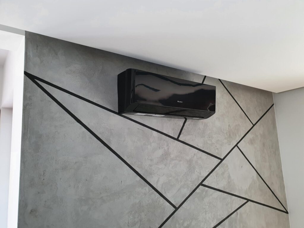 REALIZACJE 12 a black rectangular object on a wall
